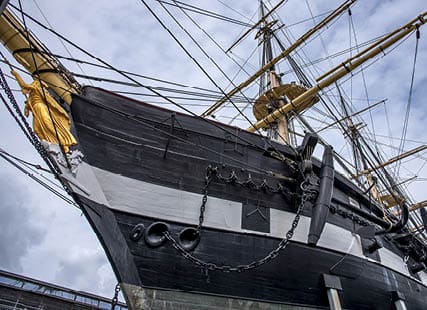 The frigate Jylland with the golden figurehead and anchor against the blue sky, Ebeltoft, September 9, 2019